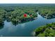 Aerial shot of a property on a lake surrounded by lush green trees at 6300 Grouse Dr, Nineveh, IN 46164