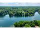Expansive aerial shot features a serene lake surrounded by lush greenery and waterfront properties at 6300 Grouse Dr, Nineveh, IN 46164
