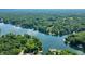 An expansive aerial view of homes along a lush, tree-lined lakefront at 6300 Grouse Dr, Nineveh, IN 46164