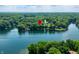 Expansive aerial shot features a serene lake surrounded by lush greenery and waterfront properties at 6300 Grouse Dr, Nineveh, IN 46164
