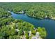 Scenic aerial view capturing a lakeside community nestled among dense trees and serene waters at 6300 Grouse Dr, Nineveh, IN 46164