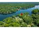 Aerial view of a lake house, identified by a red pin, surrounded by lush trees and serene water at 6300 Grouse Dr, Nineveh, IN 46164