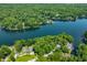 Picturesque aerial view of a lakeside community surrounded by lush greenery and a calm lake at 6300 Grouse Dr, Nineveh, IN 46164