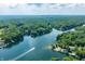 Beautiful aerial shot showcases a tranquil lake and a lush, tree-lined community from above at 6300 Grouse Dr, Nineveh, IN 46164