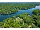 Stunning aerial view of lakefront property with lush green trees and clear blue water at 6300 Grouse Dr, Nineveh, IN 46164