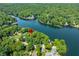 Scenic aerial view capturing a lakeside community nestled among dense trees and serene waters at 6300 Grouse Dr, Nineveh, IN 46164