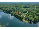 A red pin highlights a waterfront property on a tree-lined coast at 6300 Grouse Dr, Nineveh, IN 46164