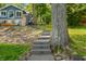 Lake house with scenic backyard featuring patio, stairs, and wooded setting at 6300 Grouse Dr, Nineveh, IN 46164