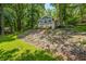 Lake house with scenic backyard featuring brick and siding exterior, and lush trees at 6300 Grouse Dr, Nineveh, IN 46164