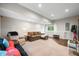 Finished basement with cozy seating, neutral walls, and ample space for entertaining or relaxing at 6300 Grouse Dr, Nineveh, IN 46164