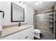 Bathroom featuring a granite countertop, large mirror, and a tiled walk-in shower with glass doors at 6300 Grouse Dr, Nineveh, IN 46164