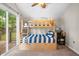 Bright bedroom with bunk beds, carpet floors, and sliding doors to the outdoor scenery at 6300 Grouse Dr, Nineveh, IN 46164