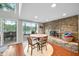 Bright dining area boasting a stone fireplace and sliding doors with lake views at 6300 Grouse Dr, Nineveh, IN 46164