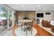 Dining room featuring a stone fireplace, wood floors and a sliding door with lake view at 6300 Grouse Dr, Nineveh, IN 46164