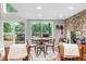 Dining area with stone fireplace and a picturesque lake view at 6300 Grouse Dr, Nineveh, IN 46164