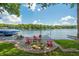 Lakeside retreat with relaxing dock and firepit area on a sunny day at 6300 Grouse Dr, Nineveh, IN 46164