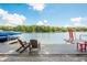 Scenic lake view from the private dock featuring inviting chairs for relaxation on a sunny day at 6300 Grouse Dr, Nineveh, IN 46164