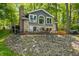 Charming brick home featuring a lakeside patio and serene views surrounded by lush trees at 6300 Grouse Dr, Nineveh, IN 46164