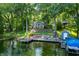 Lakeside home with dock, lush greenery, and ample outdoor seating at 6300 Grouse Dr, Nineveh, IN 46164