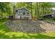 Back of lakeside home featuring brick exterior, large windows, and peaceful wooded setting at 6300 Grouse Dr, Nineveh, IN 46164