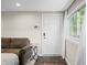 Hallway with brown sofa, a white door, a window and tile flooring at 6300 Grouse Dr, Nineveh, IN 46164