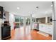 Open-concept kitchen with wood flooring, stainless steel appliances and a large lake view at 6300 Grouse Dr, Nineveh, IN 46164