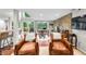 Open living room with stone fireplace, TV, and sliding door access to the deck at 6300 Grouse Dr, Nineveh, IN 46164
