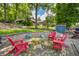 Charming outdoor patio with cozy seating around a fire pit offering a serene view of the lush green surroundings and lake at 6300 Grouse Dr, Nineveh, IN 46164