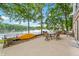 Lakeside patio offering serene water views, complete with comfortable dining furniture for outdoor relaxation and enjoyment at 6300 Grouse Dr, Nineveh, IN 46164