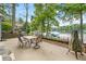 Inviting patio with lake views, complete with outdoor dining set and grill, perfect for entertaining and enjoying the scenery at 6300 Grouse Dr, Nineveh, IN 46164