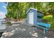 Quaint blue shed and bench on the dock offering convenient storage and seating with picturesque lake views at 6300 Grouse Dr, Nineveh, IN 46164
