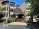 Well-maintained condo building with elegant covered entrance and manicured landscaping at 8577 One W Dr # 301, Indianapolis, IN 46260