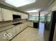 Modern kitchen with granite countertops, stainless steel appliances, and tile flooring at 8577 One W Dr # 301, Indianapolis, IN 46260