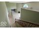 Bright living room showcasing an open layout with a fireplace and staircase, complemented by neutral-toned walls at 8577 One W Dr # 301, Indianapolis, IN 46260