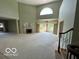 Open-concept living area with fireplace, large windows, and staircase access at 8577 One W Dr # 301, Indianapolis, IN 46260