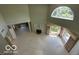 Open living room featuring a fireplace, high ceilings, large windows, and a neutral-colored carpet, offering great light at 8577 One W Dr # 301, Indianapolis, IN 46260