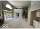 Expansive living room with tall windows, fireplace, wet bar and staircase at 8577 One W Dr # 301, Indianapolis, IN 46260