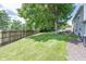 Spacious backyard with a lush lawn, mature trees, and a fenced perimeter at 12602 Lockerbie Cir, Carmel, IN 46033