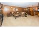 Finished basement featuring a sectional sofa, coffee table, adjacent bar area, and decorative wall accents at 12602 Lockerbie Cir, Carmel, IN 46033