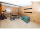 Cozy basement room with an exercise bike, small round table, and colorful trunk, offering a versatile space at 12602 Lockerbie Cir, Carmel, IN 46033