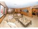 Basement living area with a sectional sofa, wooden coffee table, wet bar, and decorated with boxing themed art at 12602 Lockerbie Cir, Carmel, IN 46033