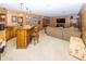 Finished basement with a wet bar, wooden barstools, a comfortable sofa, and ample space for entertaining at 12602 Lockerbie Cir, Carmel, IN 46033