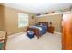 Cozy bedroom with a wooden bed frame, blue bedding, plush carpeting, and a window providing natural light at 12602 Lockerbie Cir, Carmel, IN 46033