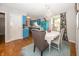 Bright dining area featuring unique blue cabinets, hardwood floors, and natural light at 12602 Lockerbie Cir, Carmel, IN 46033