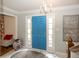 Bright entryway featuring a striking blue front door, marble flooring, and elegant chandelier at 12602 Lockerbie Cir, Carmel, IN 46033