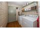 A functional laundry room with patterned wallpaper and ample shelving for storage at 12602 Lockerbie Cir, Carmel, IN 46033