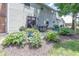 Brick patio with outdoor dining set surrounded by lush landscaping and flowering plants at 12602 Lockerbie Cir, Carmel, IN 46033