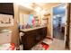 Bathroom with a double sink vanity, granite countertop and decorative rugs for a cozy feel at 1266 Hamilton Dr, Greenwood, IN 46143