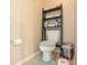 Toilet and metal shelving unit with ample storage space in half bath at 1266 Hamilton Dr, Greenwood, IN 46143