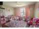 Playroom with a window with pink curtains, colorful rug and lots of toys at 1266 Hamilton Dr, Greenwood, IN 46143